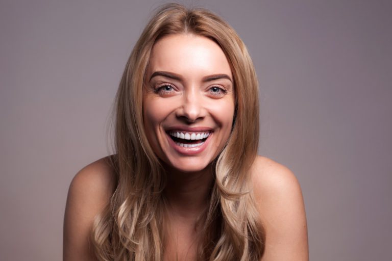 Woman with a confident straight smile after visiting her Arcadia orthodontist