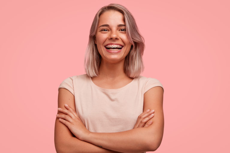 Young woman smiling with braces from an Arcadia orthodontist